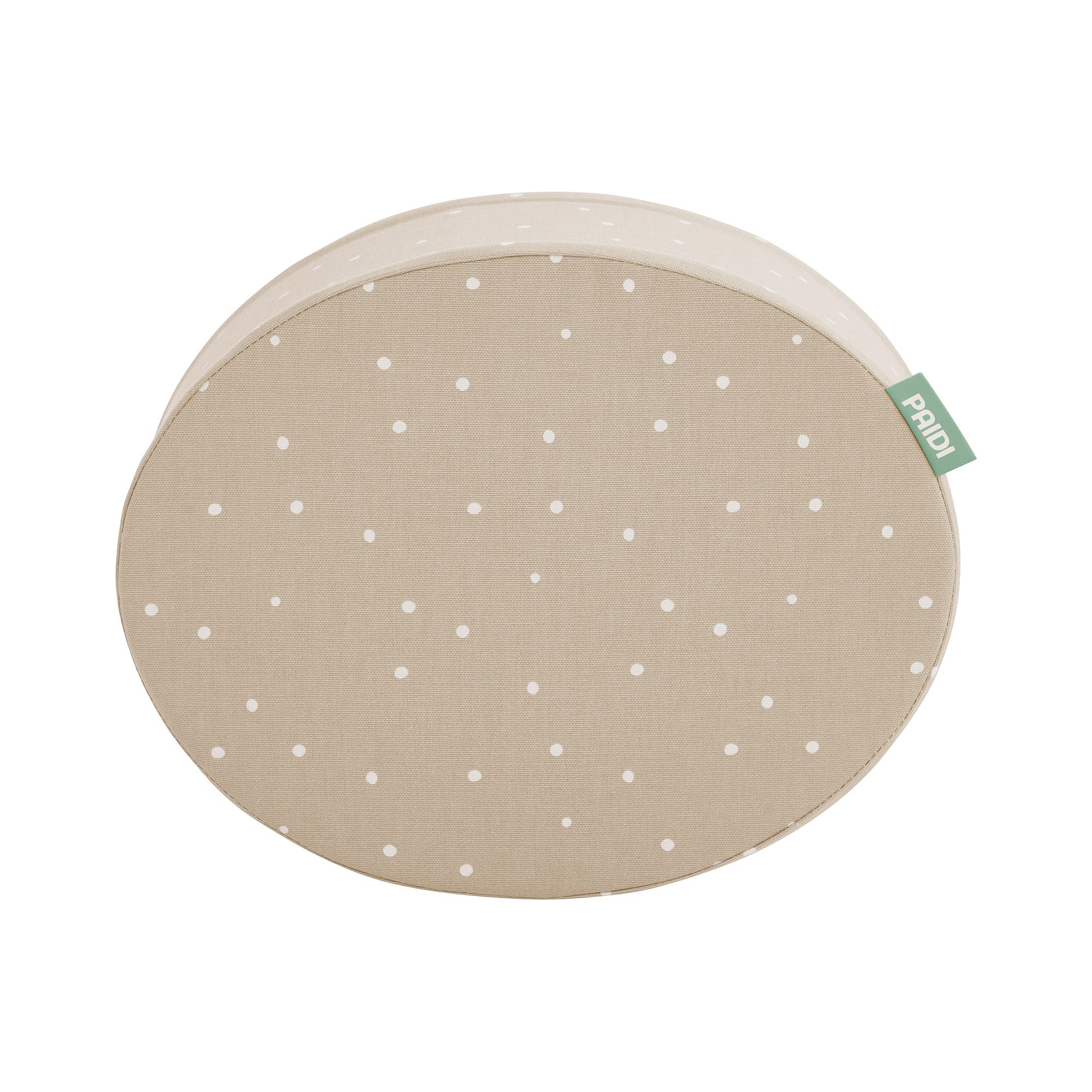 Beigefarbenes rundes Kissen mit weißen Tupfen und einem grünen Stoffanhänger an der Seite.