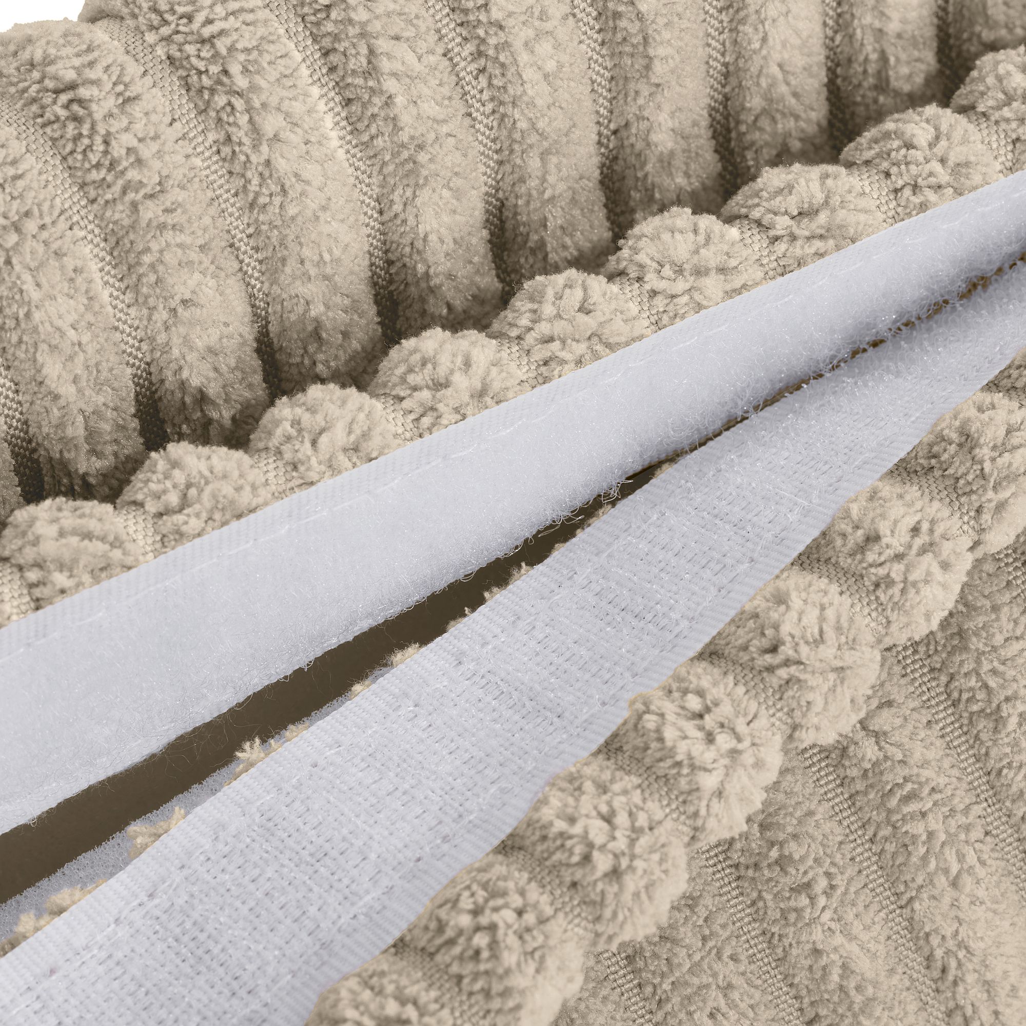 Nahaufnahme eines beigefarbenen strukturierten Stoffes mit einem weißen Klettverschlussstreifen.