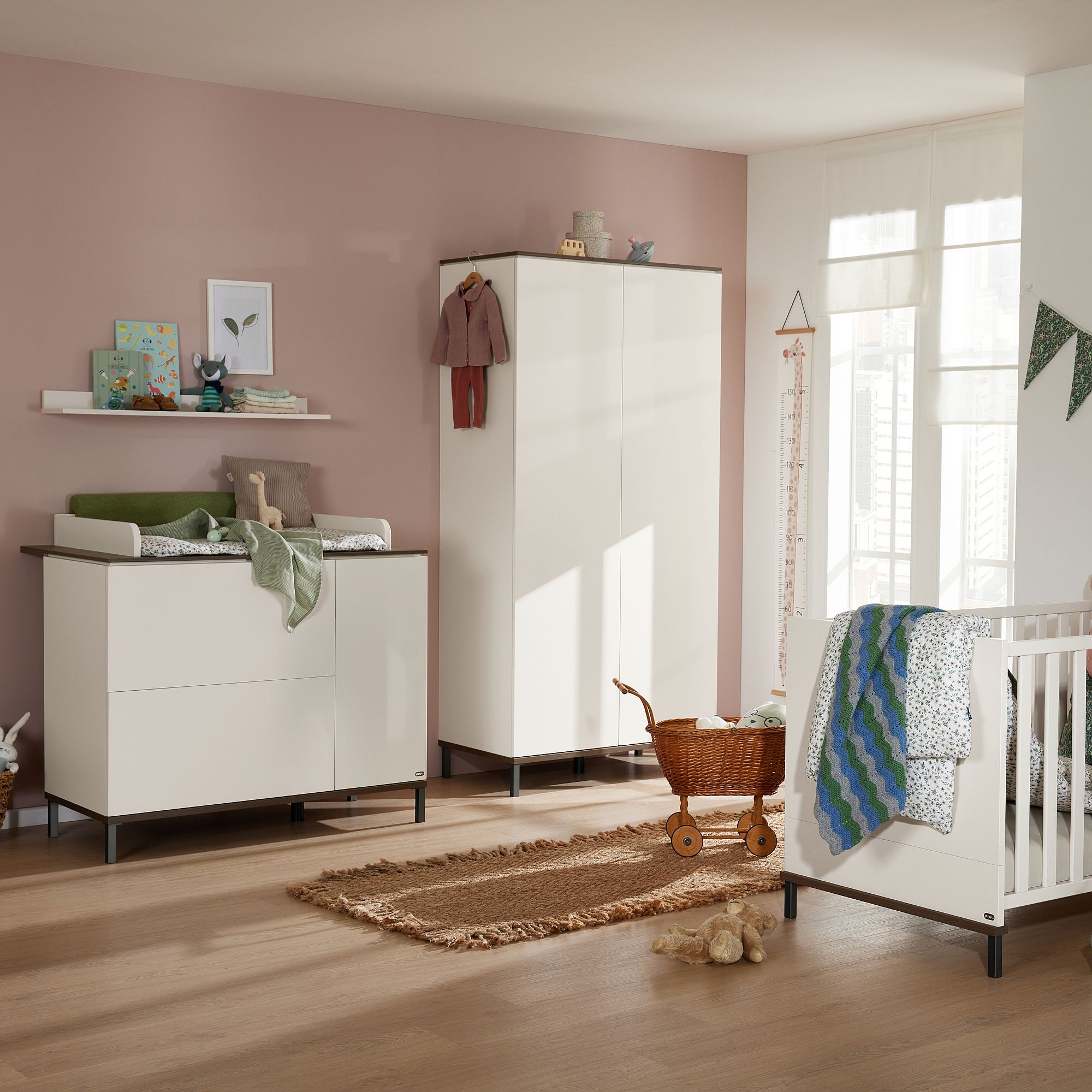 Modernes Kinderzimmer mit Kinderbett, Kommode, Kleiderschrank und Spielzeug auf einem Holzboden.