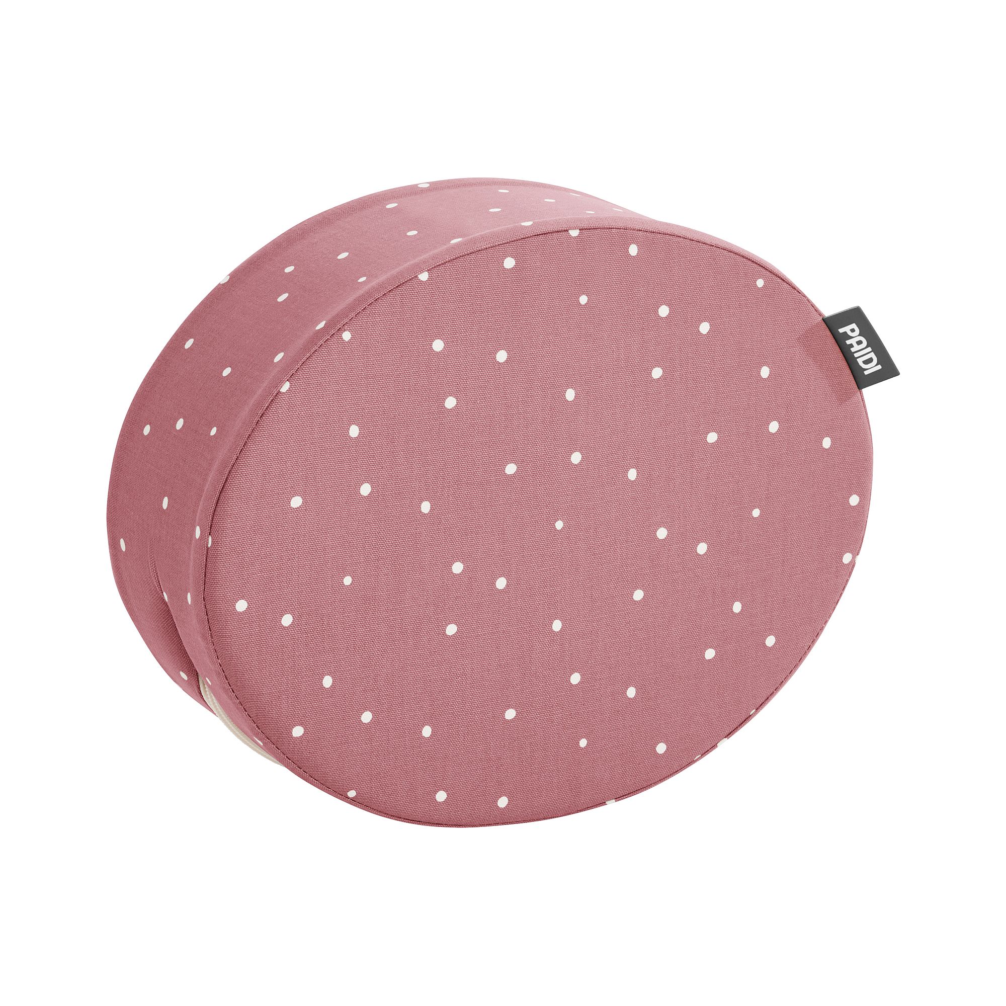 Rosafarbenes rundes Kissen mit weißen Tupfen und einem kleinen schwarzen Etikett an der Seite.